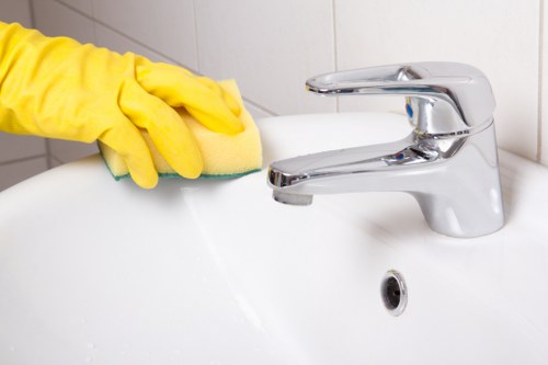 Kitchen surfaces being wiped as part of house cleaning routine
